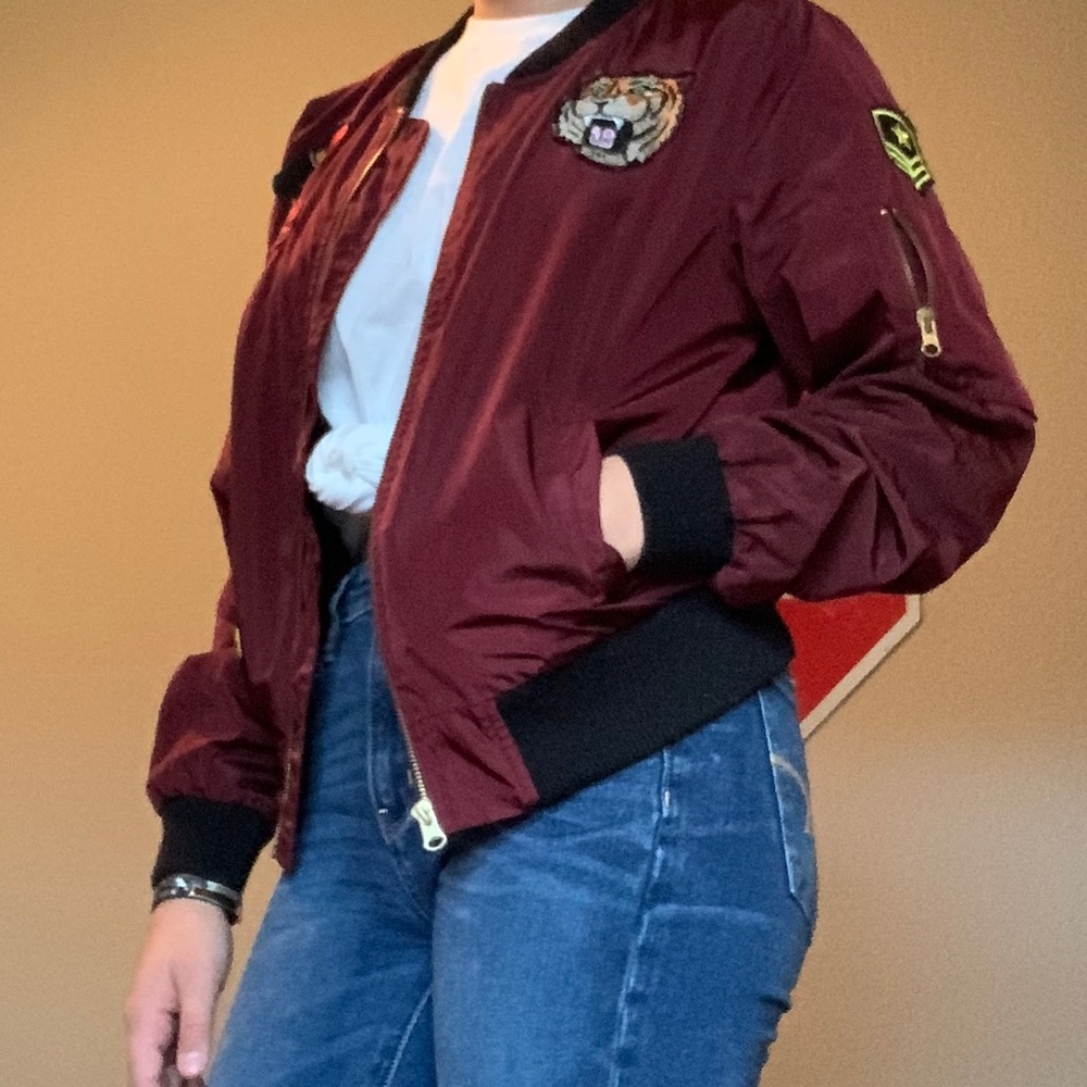 A burgundy bomber/ windbreaker jacket